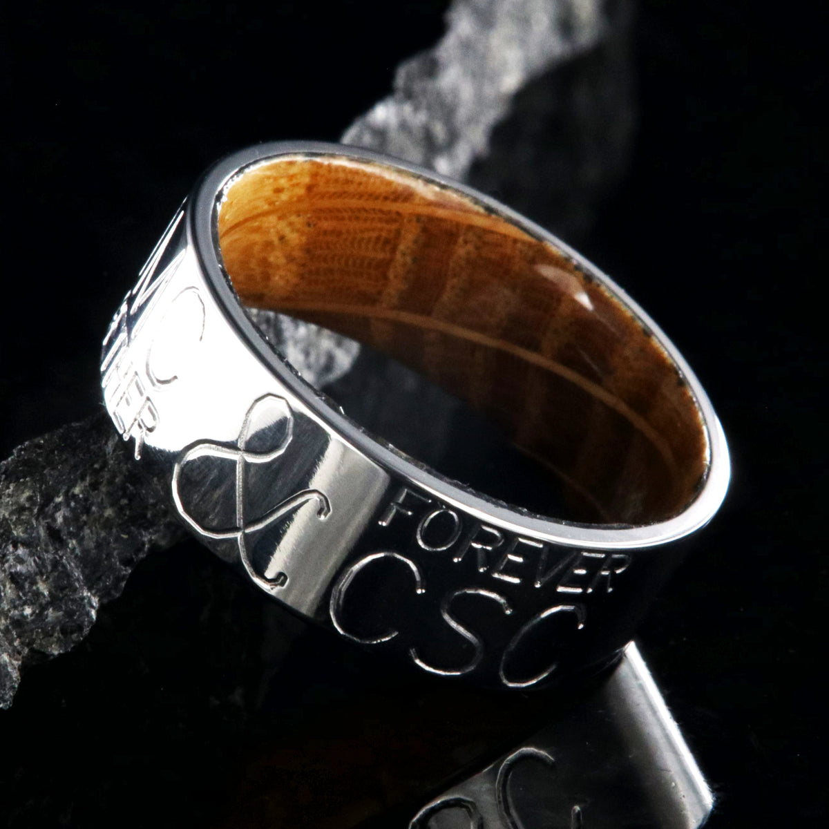 8mm wide personalized duck band ring; polished titanium with two lines of text on either side of an &amp;; polished Jack Daniel&#39;s whiskey barrel sleeve
