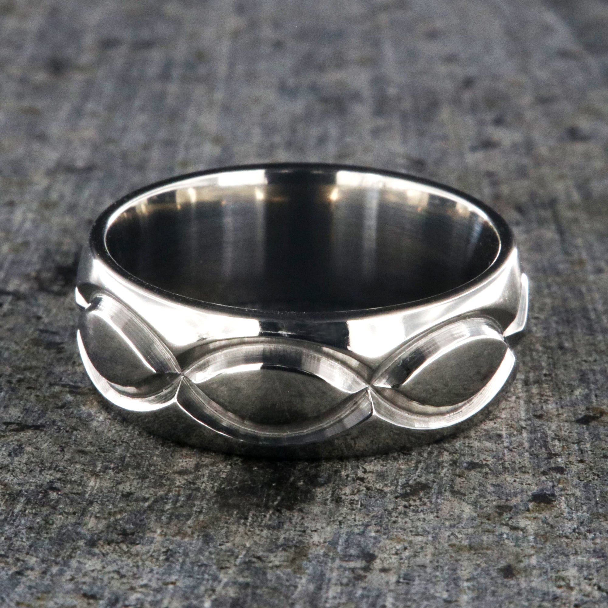 8mm wide titanium wedding band with a milled infinity design and rounded profile