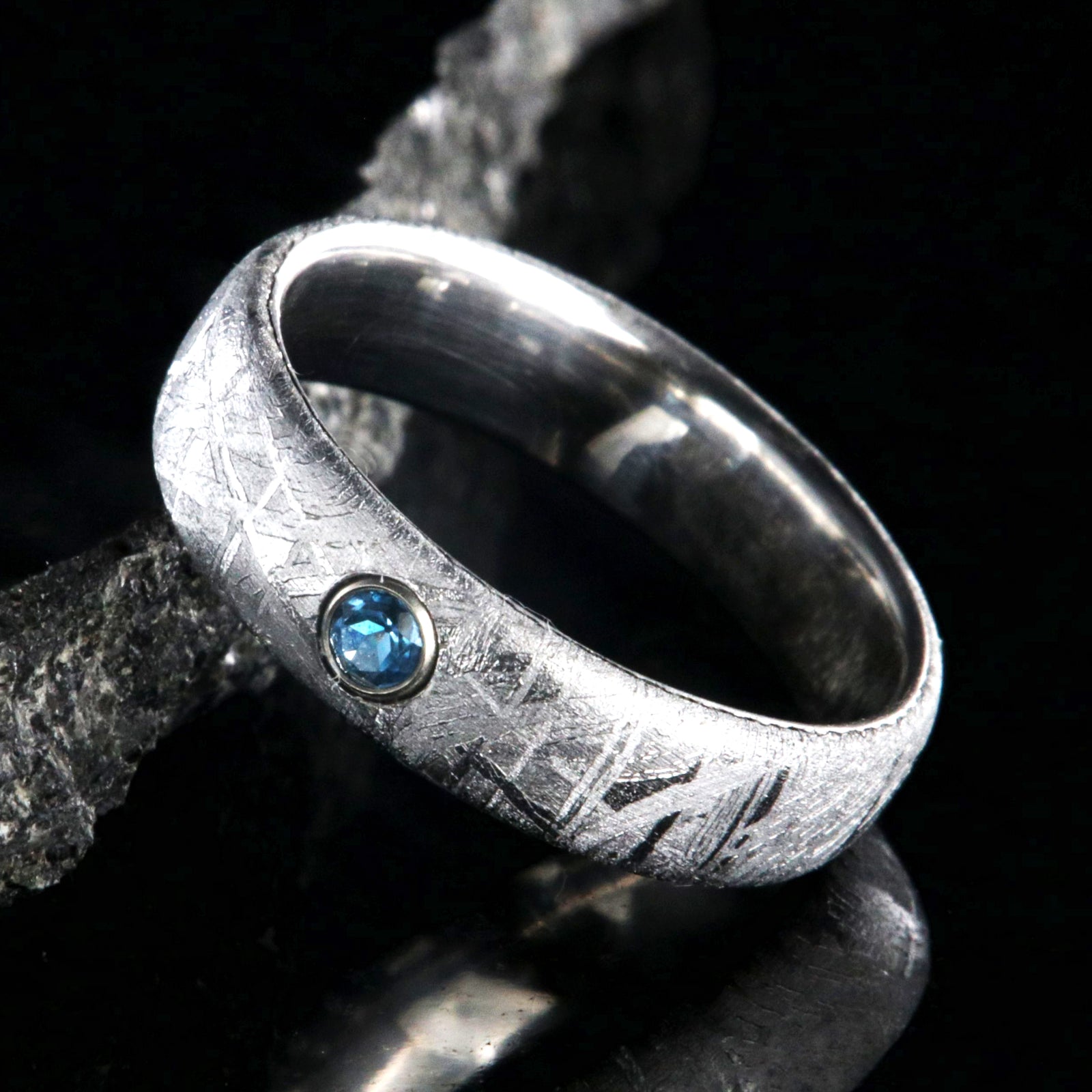 5mm wide women's meteorite ring with a blue topaz set in 14k gold bezel