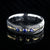 6mm wide black Damascus steel wedding band with 3 blue sapphire stone with a yellow gold center inlay