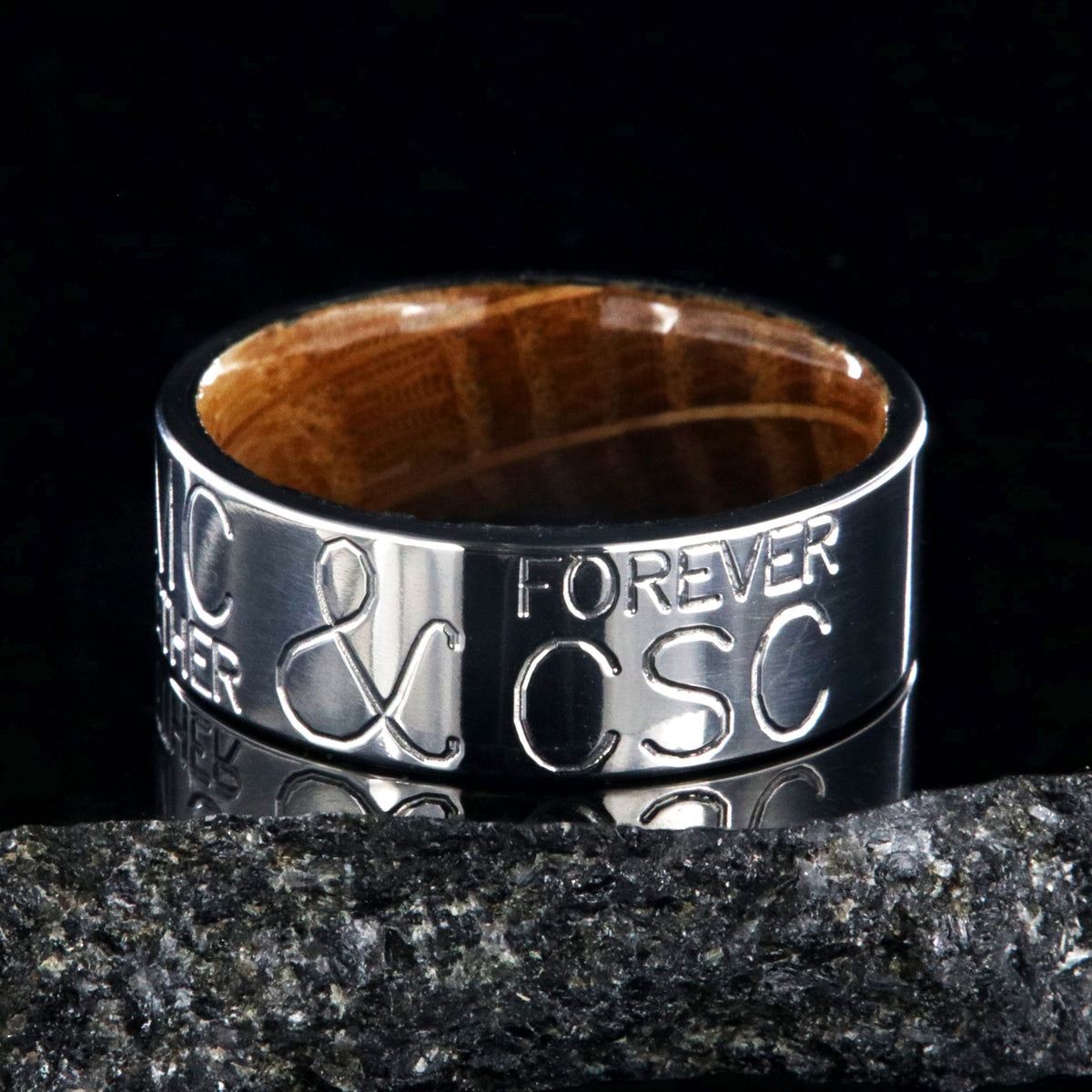 8mm wide personalized duck band ring; polished titanium with two lines of text on either side of an &amp;; polished Jack Daniel&#39;s whiskey barrel sleeve