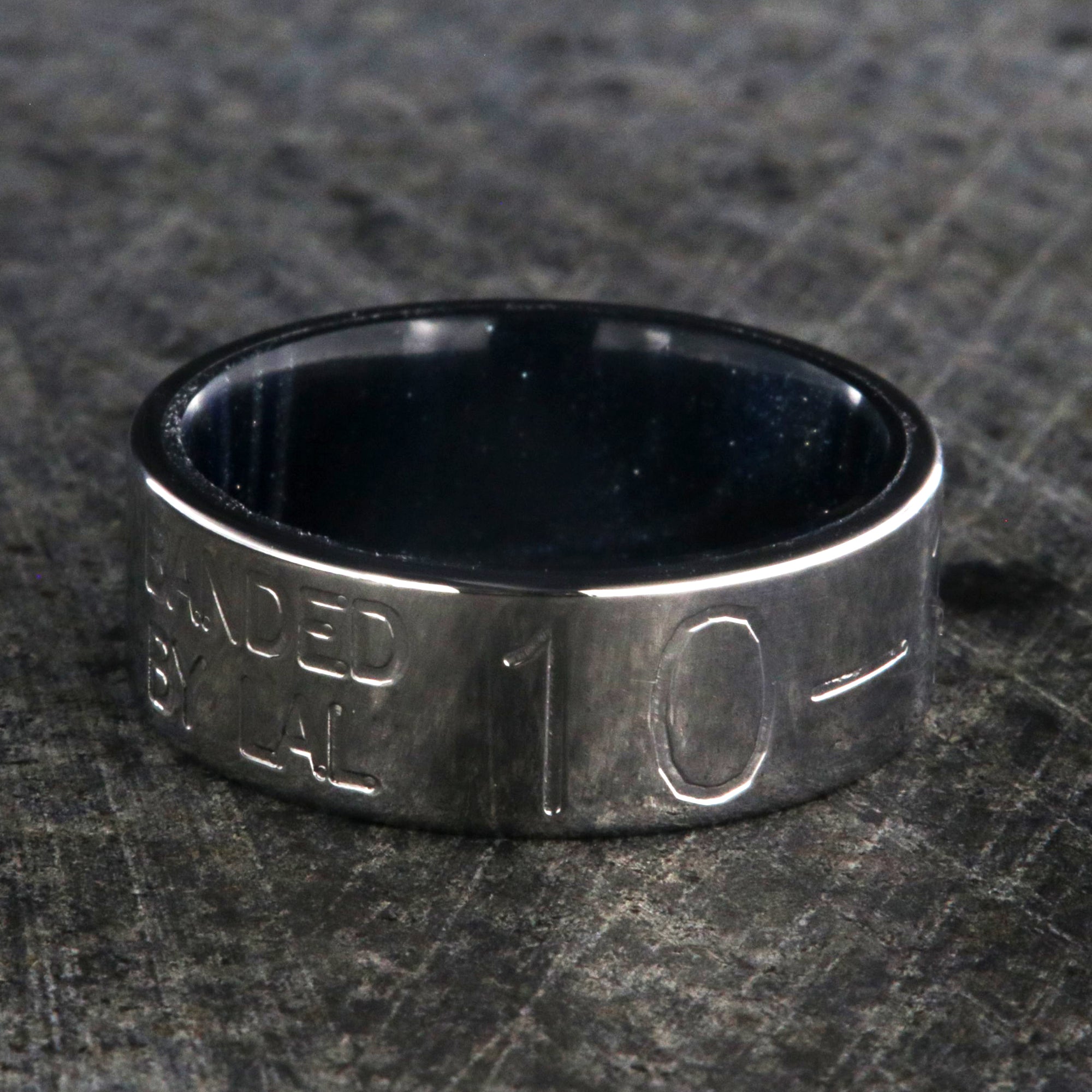 8mm wide duck band titanium ring with two lines of text adjacent to large numbers with dark blue sleeve