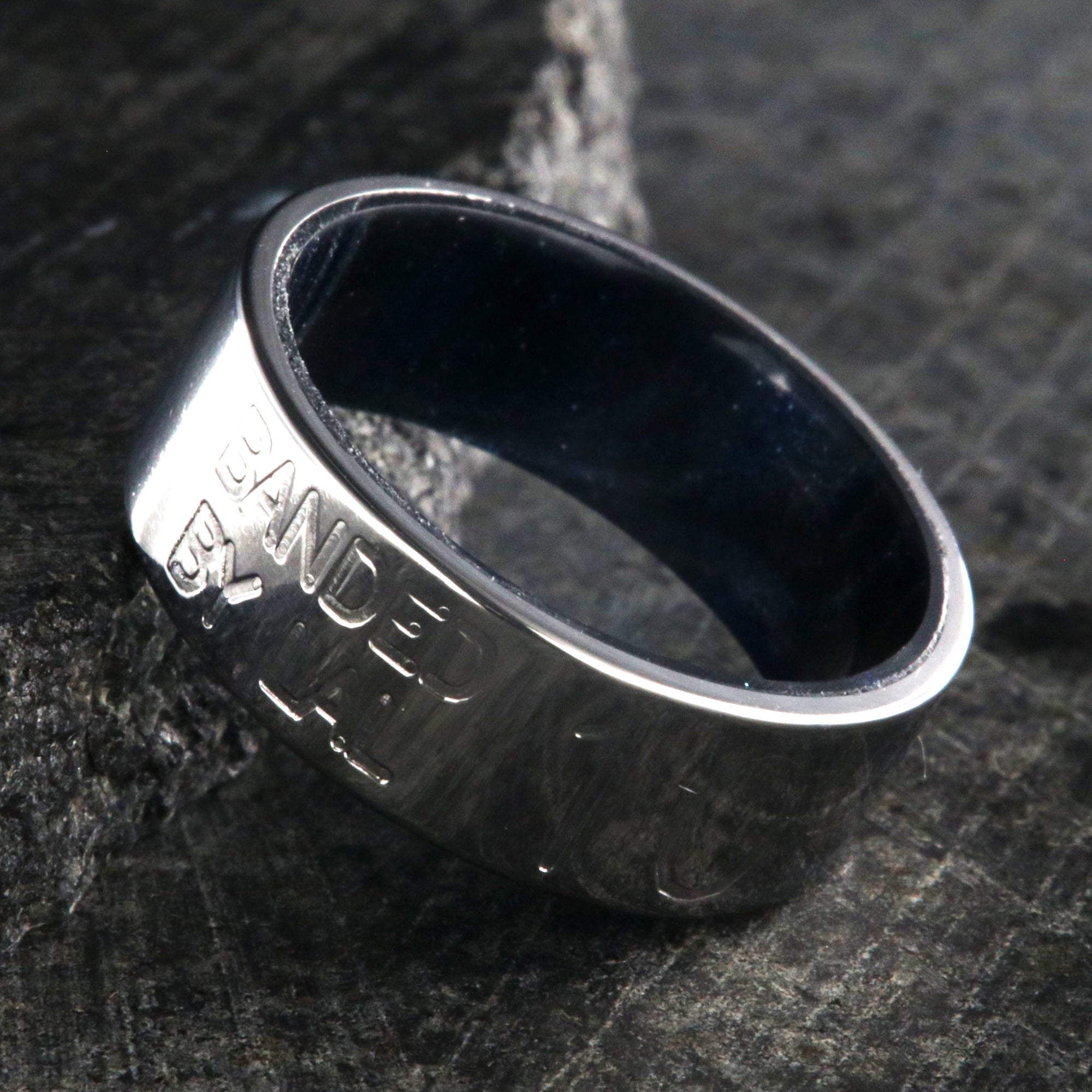8mm wide duck band titanium ring with two lines of text adjacent to large numbers with dark blue sleeve