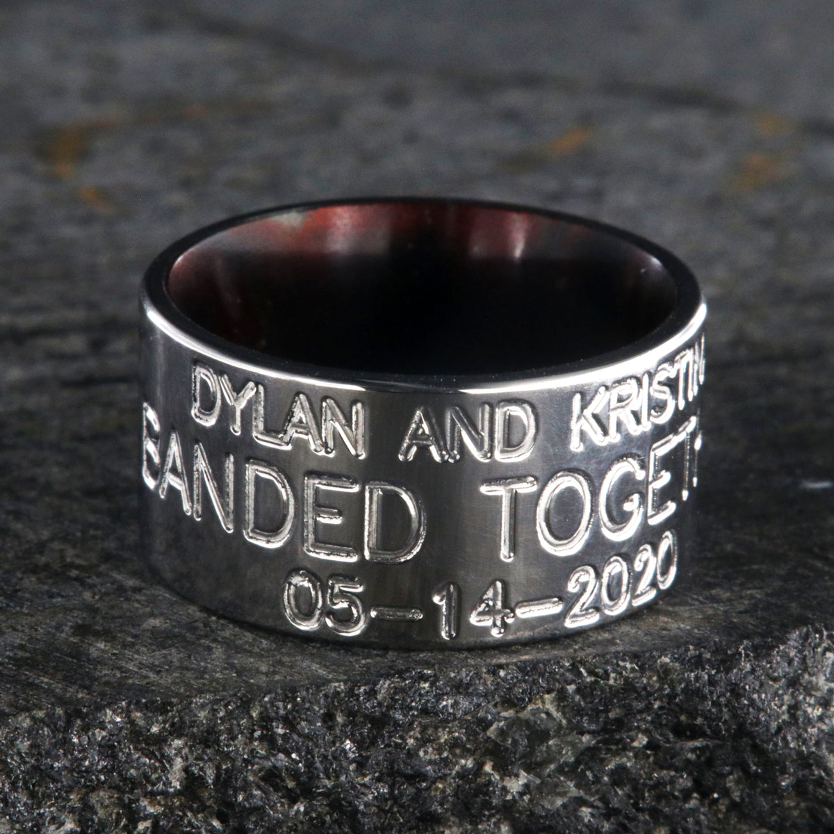 12mm wide titanium duck band ring with 3 lines of text with a dark red sleeve