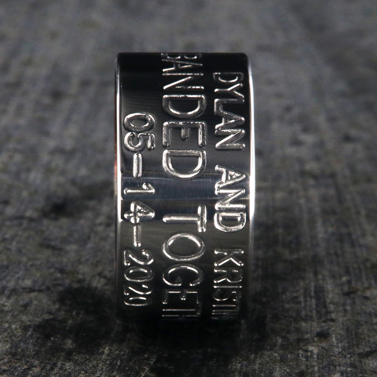 12mm wide titanium duck band ring with 3 lines of text with a dark red sleeve