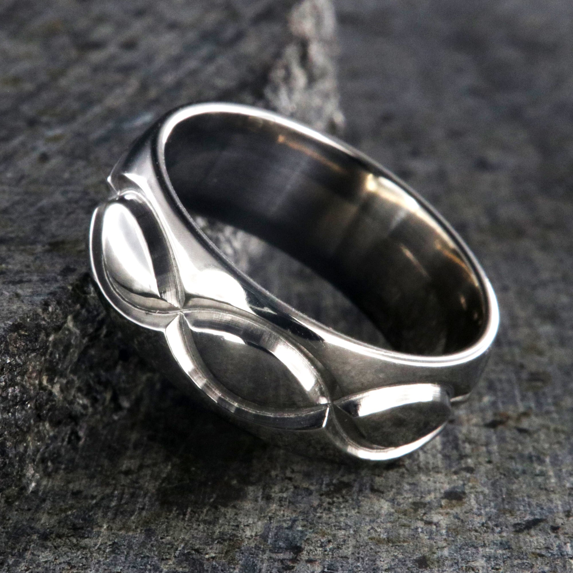 8mm wide titanium wedding band with a milled infinity design and rounded profile