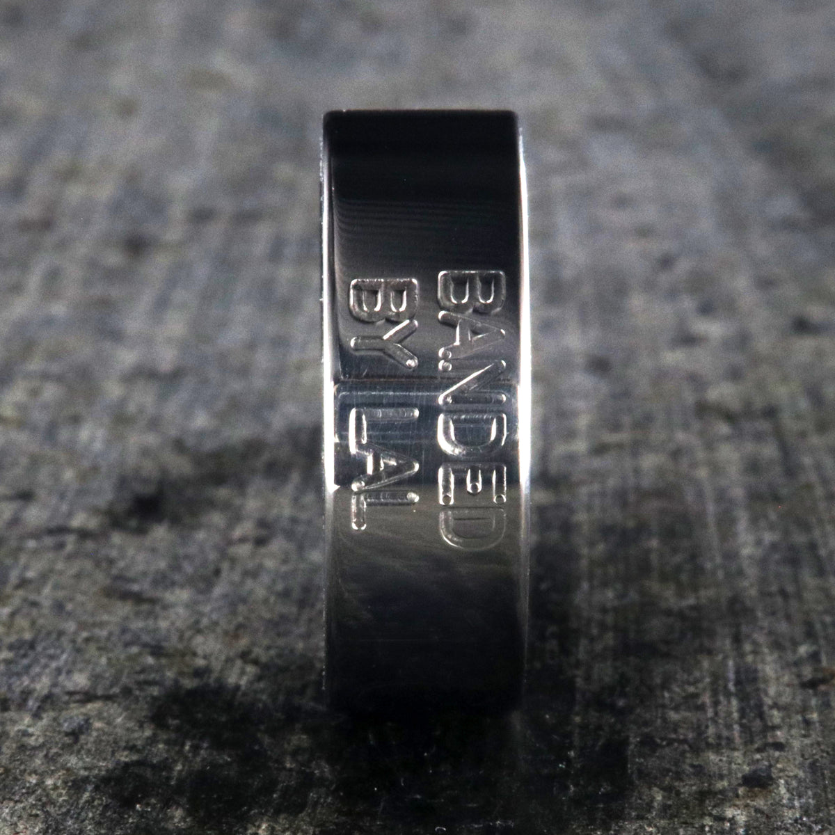 8mm wide duck band titanium ring with two lines of text adjacent to large numbers with dark blue sleeve