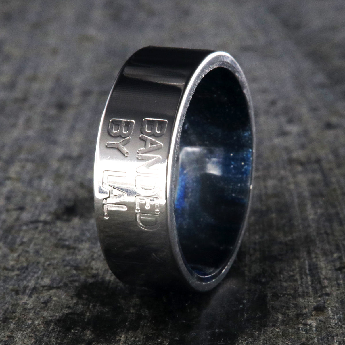 8mm wide duck band titanium ring with two lines of text adjacent to large numbers with dark blue sleeve