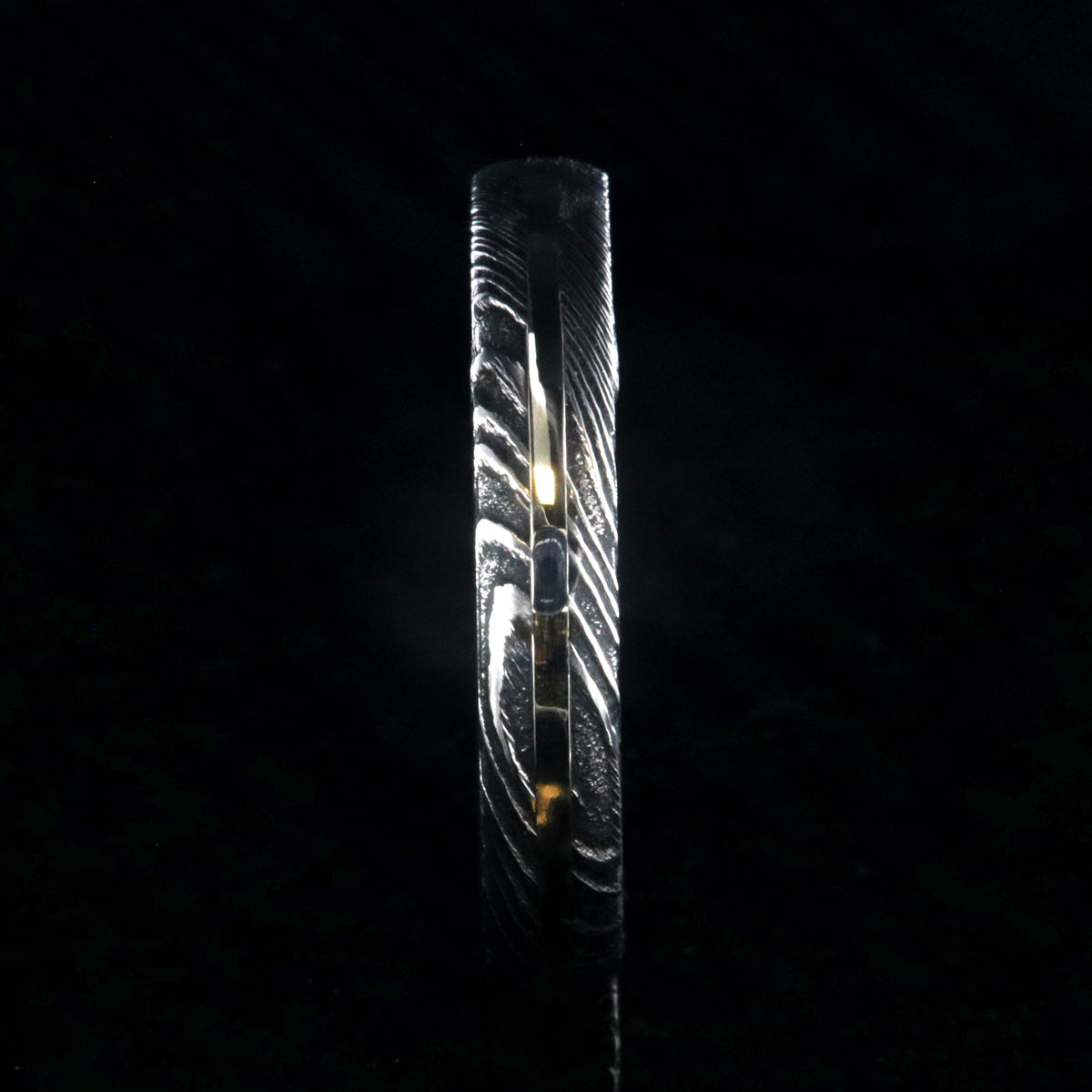 4mm wide black Damascus steel wedding band with a white gold inlay, Arizona ironwood sleeve, and a rounded profile