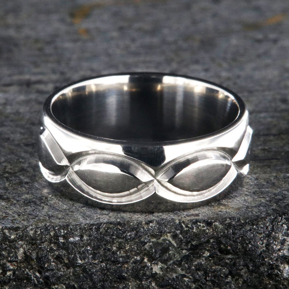 8mm wide titanium wedding band with a milled infinity design and rounded profile