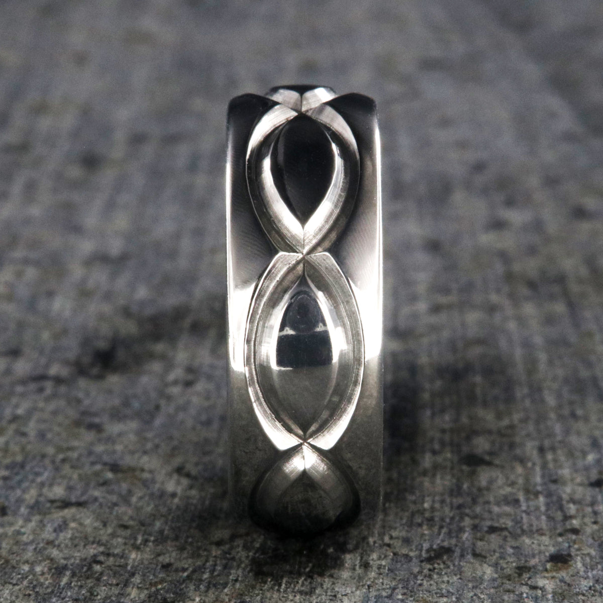8mm wide titanium wedding band with a milled infinity design and rounded profile