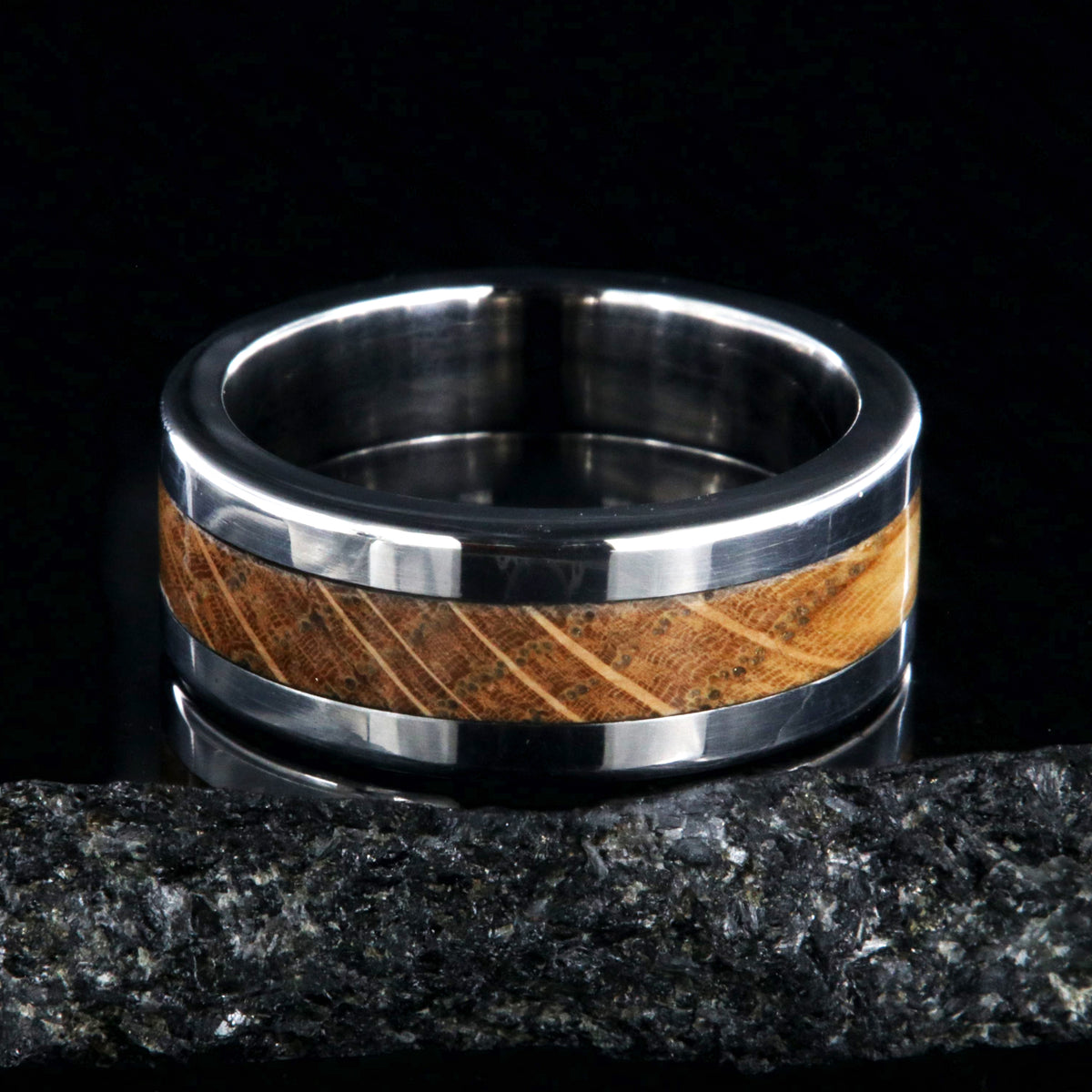 8mm wide wedding band with titanium edges and a whiskey barrel sleeve