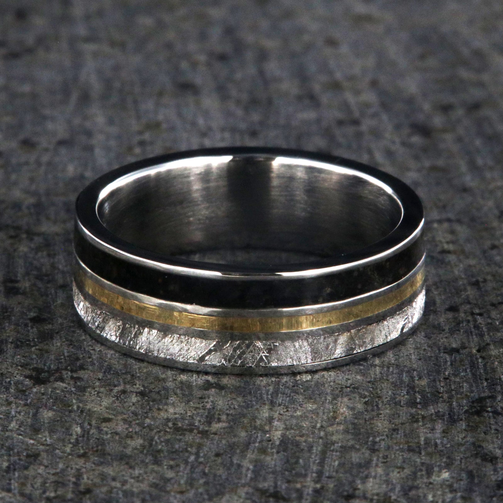7mm wide wedding band with yellow gold center inlay, Gibeon meteorite edge, dinosaur bone edge, and cobalt sleeve