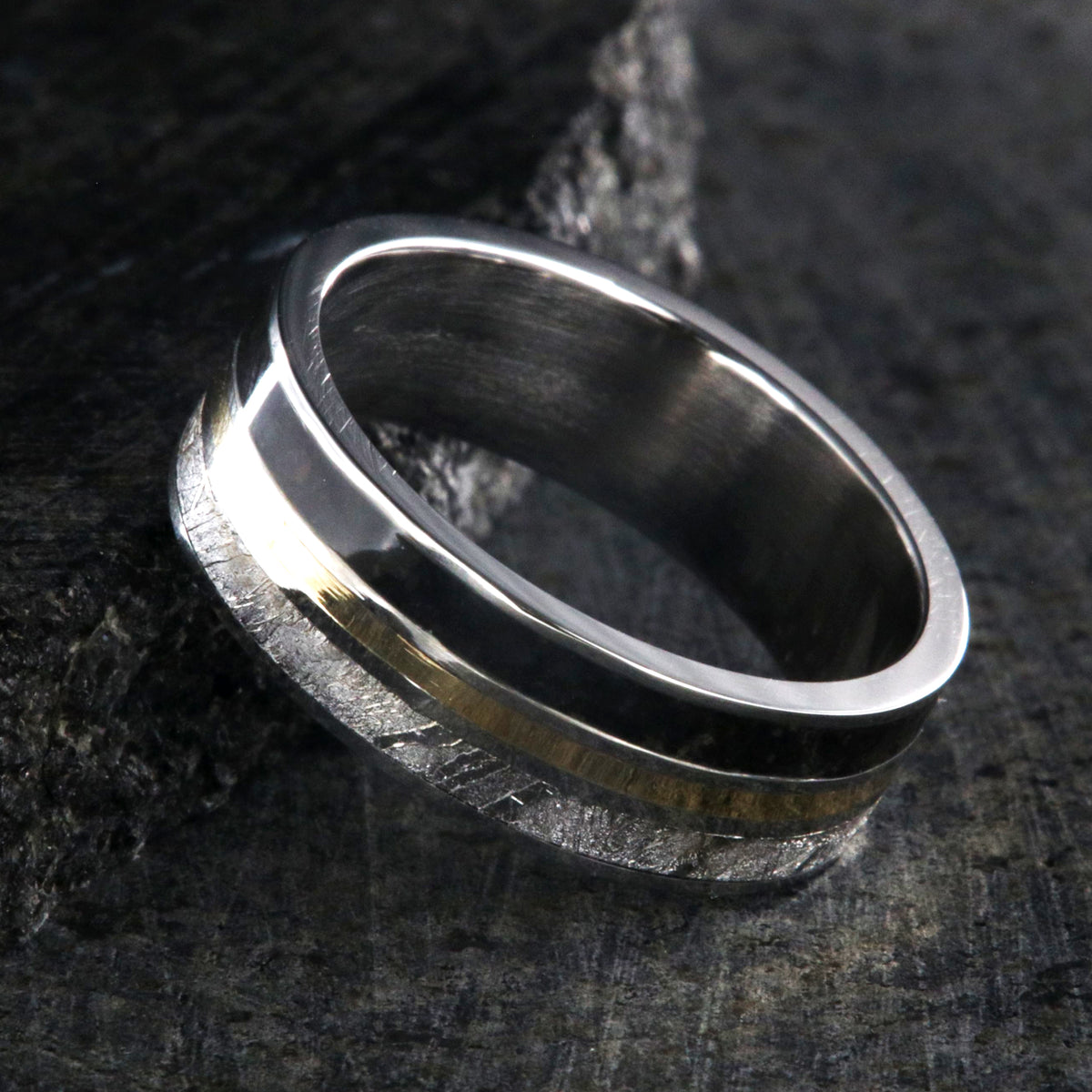 7mm wide wedding band with yellow gold center inlay, Gibeon meteorite edge, dinosaur bone edge, and cobalt sleeve