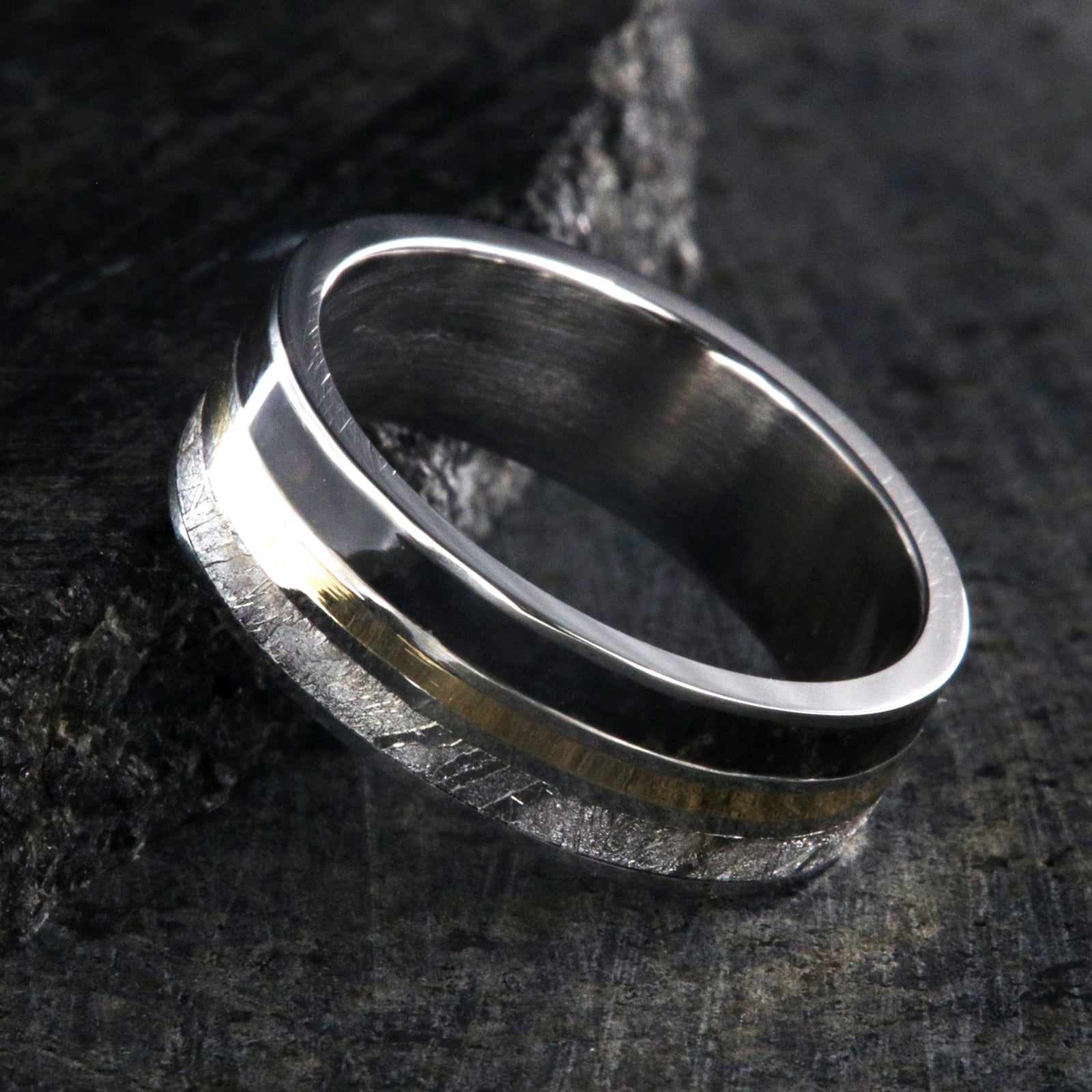 7mm wide wedding band with yellow gold center inlay, Gibeon meteorite edge, dinosaur bone edge, and cobalt sleeve
