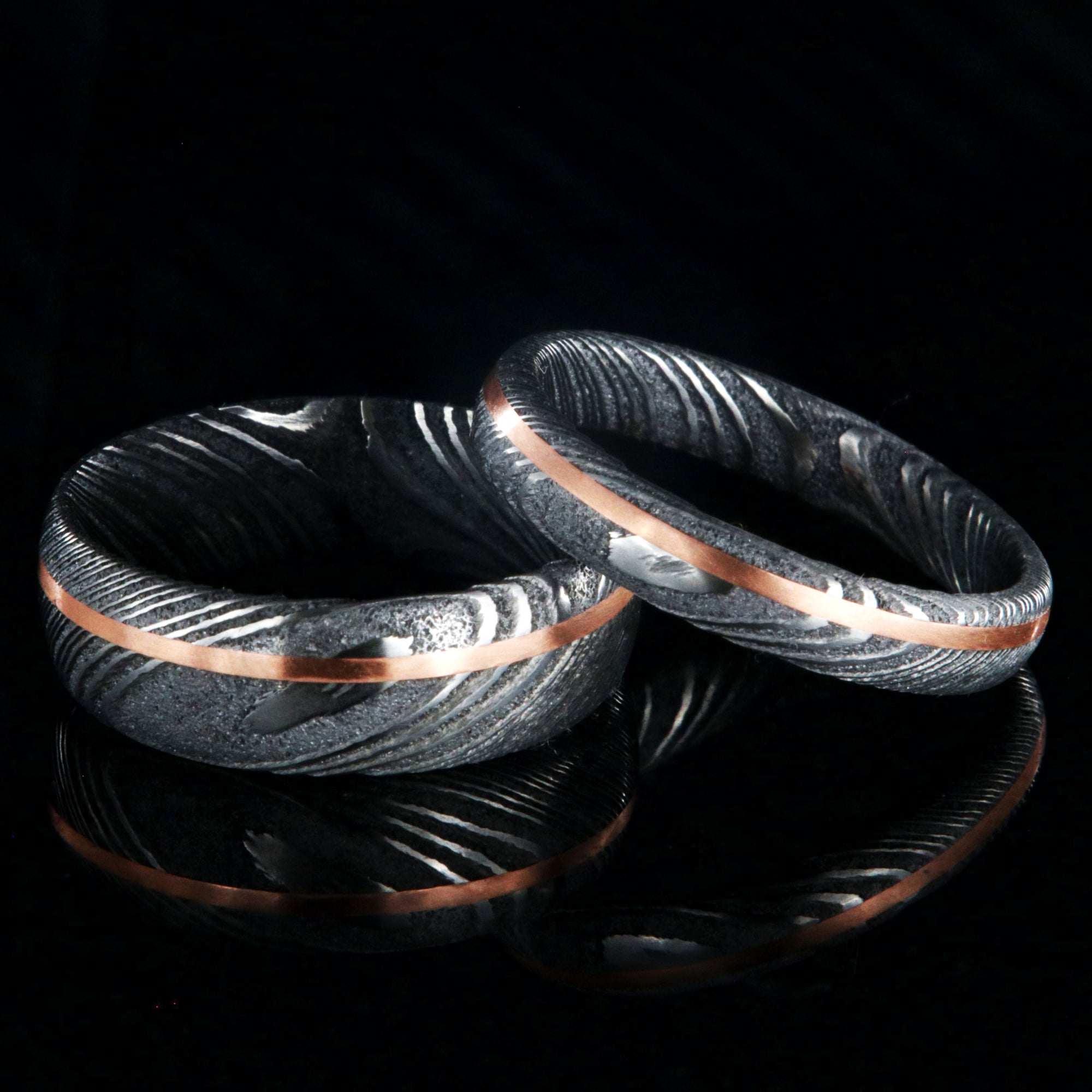Matching his and her Damascus steel ring set. 7mm and 4mm wide Damascus steel rings with copper inlay