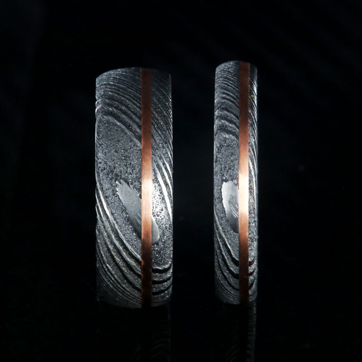 Matching his and her Damascus steel ring set. 7mm and 4mm wide Damascus steel rings with copper inlay