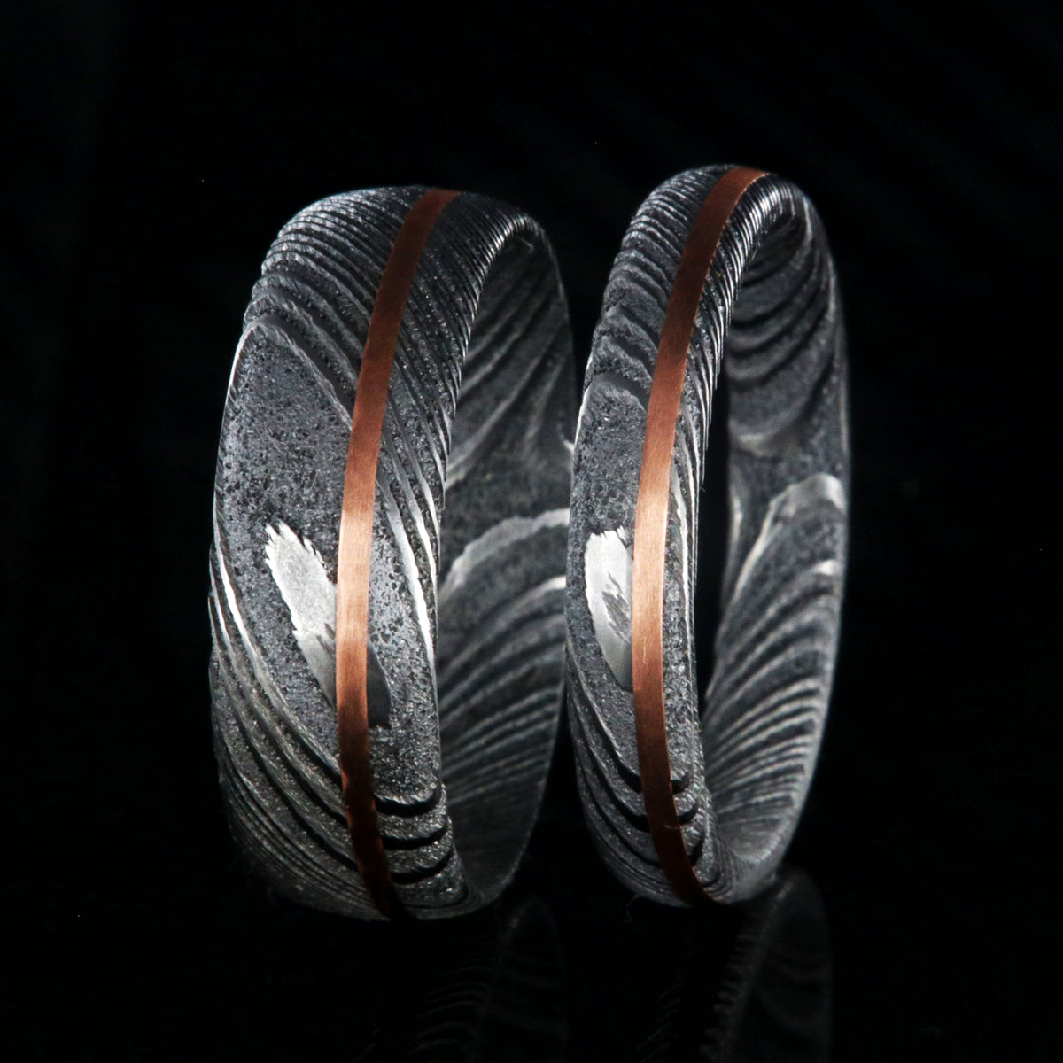 Matching his and her Damascus steel ring set. 7mm and 4mm wide Damascus steel rings with copper inlay