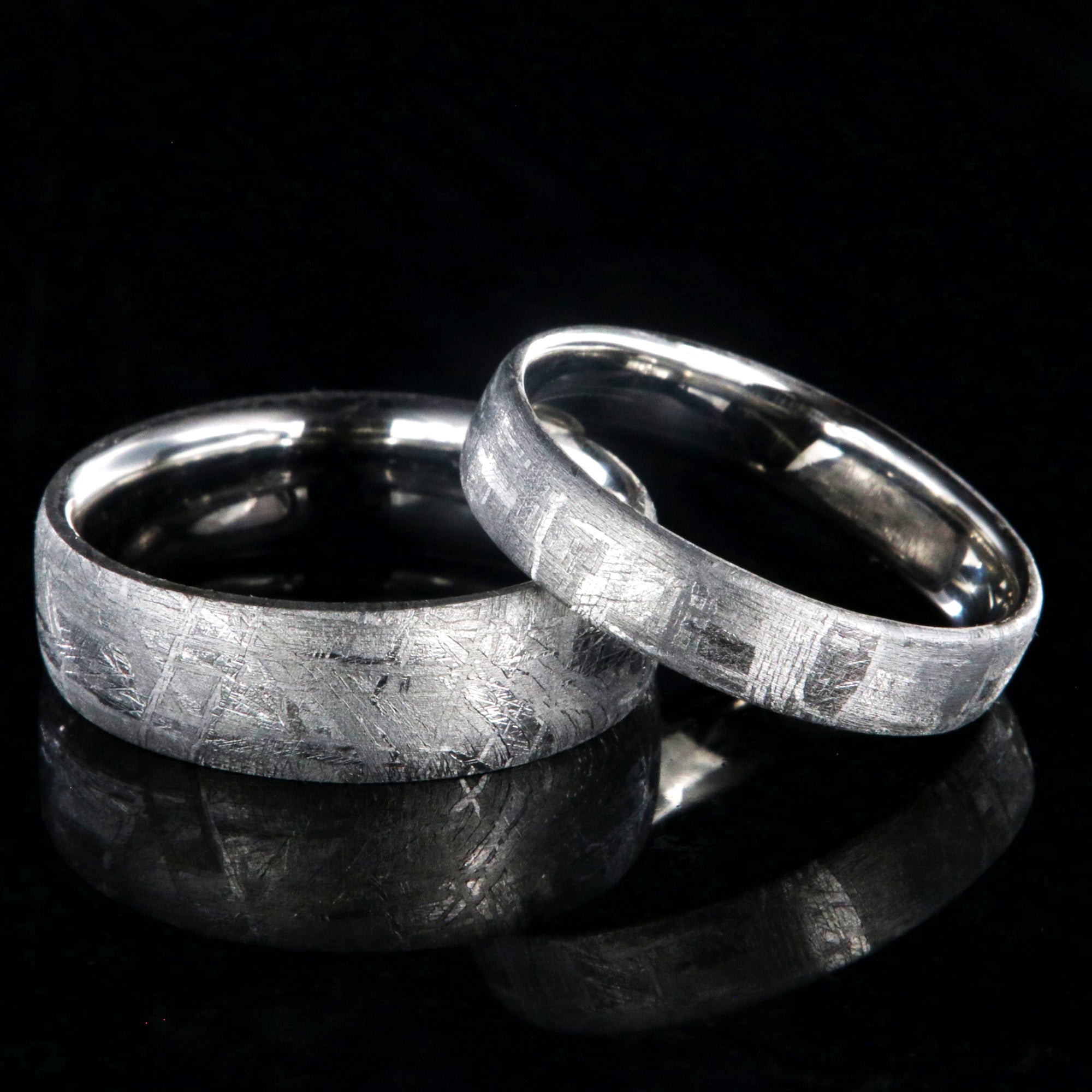 His and her matching ring set with a 7mm wide and 5mm wide Gibeon meteorite rings