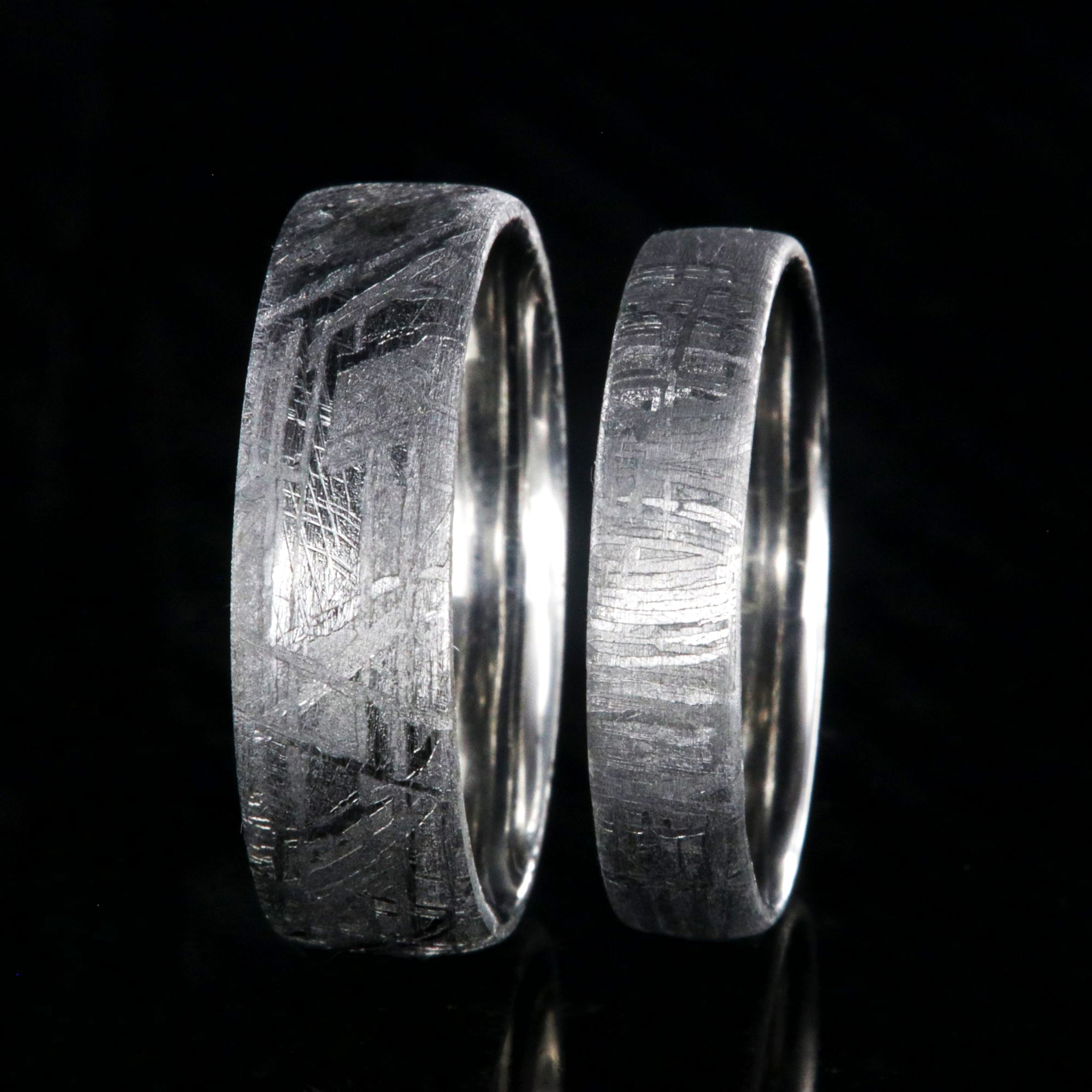 His and her matching ring set with a 7mm wide and 5mm wide Gibeon meteorite rings