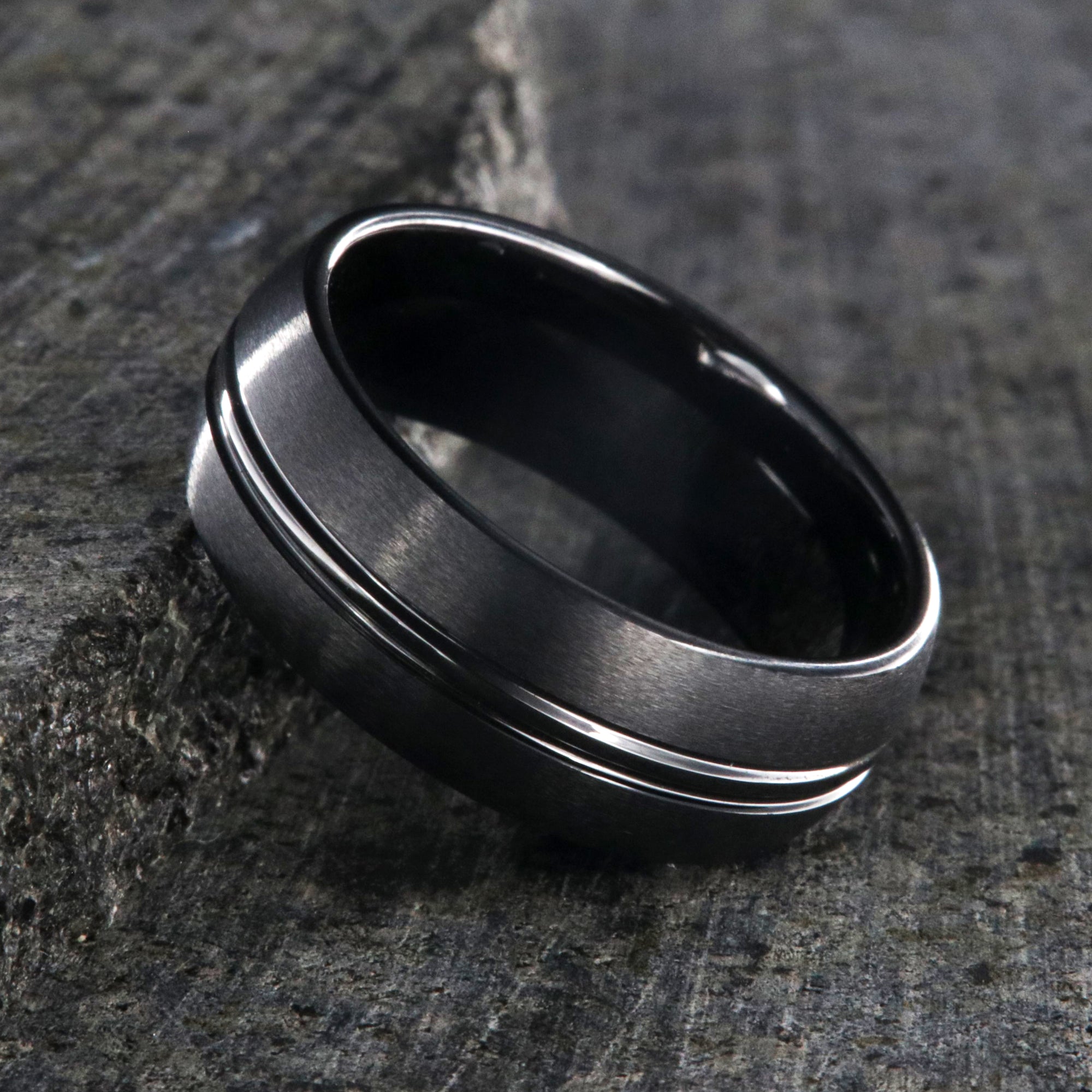 8mm wide black titanium wedding band with a center dual groove and rounded profile