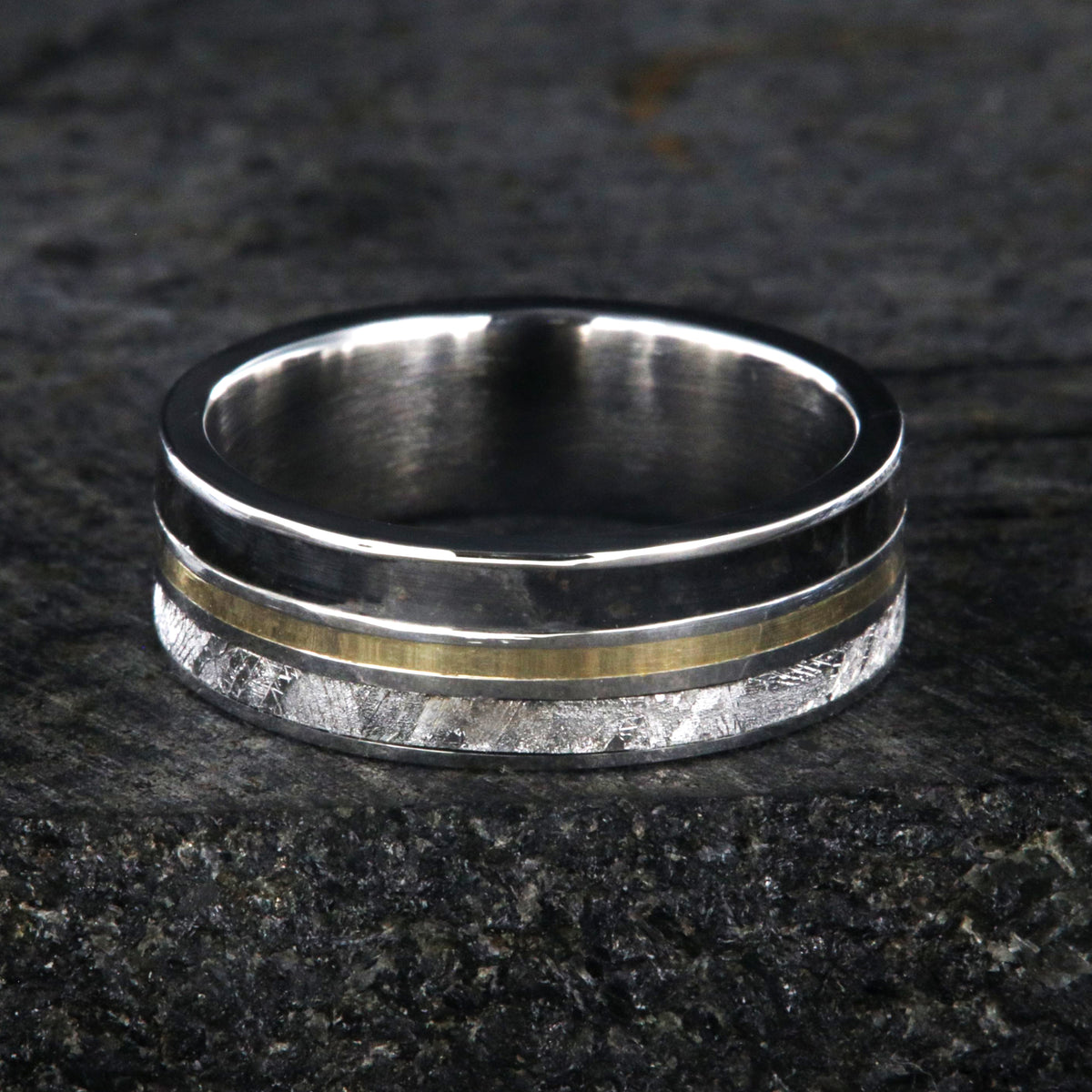 7mm wide wedding band with yellow gold center inlay, Gibeon meteorite edge, dinosaur bone edge, and cobalt sleeve