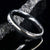 4mm wide black Damascus steel wedding band with a white gold inlay
