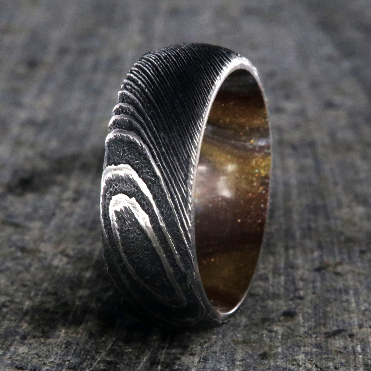 8mm wide Damascus steel ring for me with a copper and brown glittered sleeve
