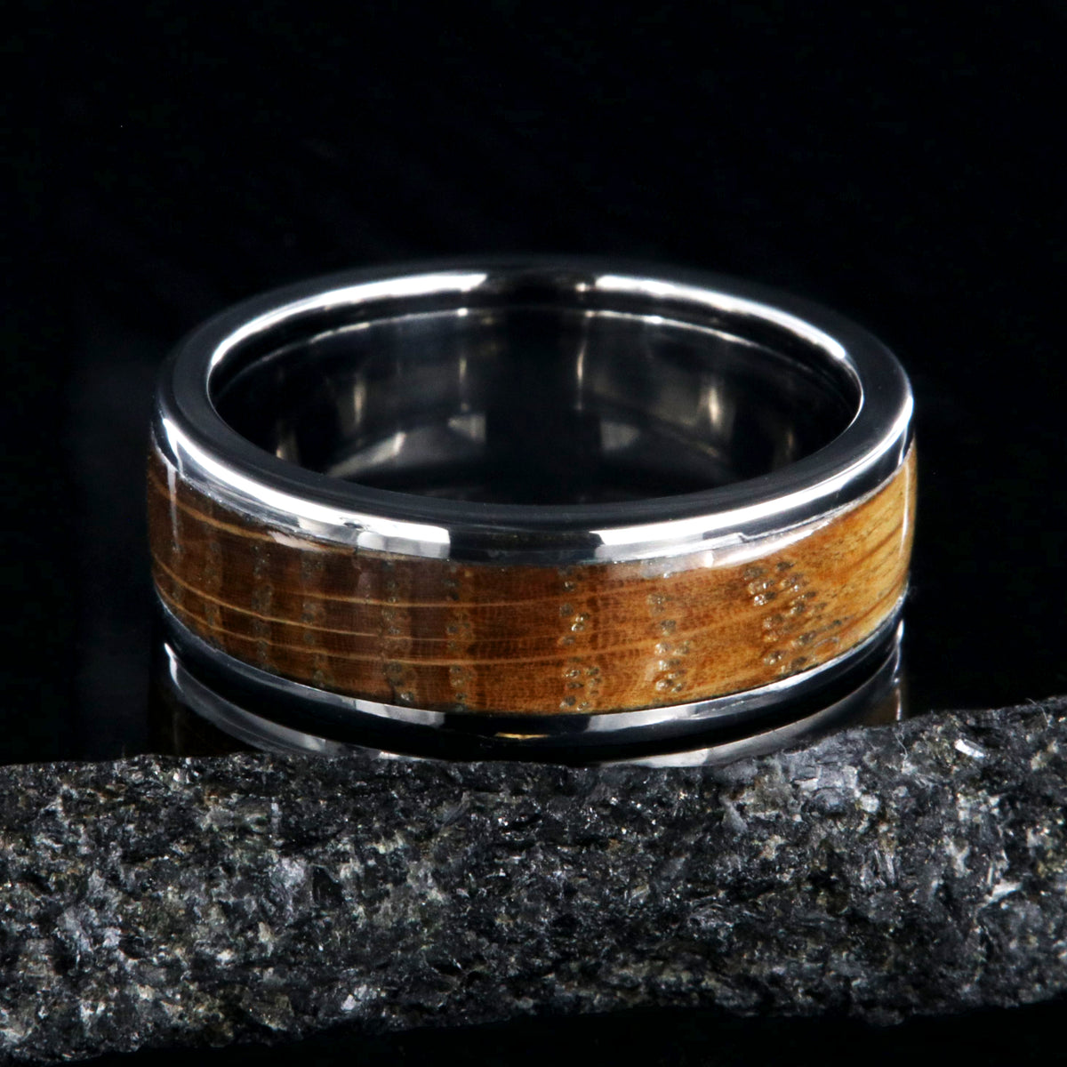 7mm wide wedding band with titanium edges and a whiskey barrel sleeve