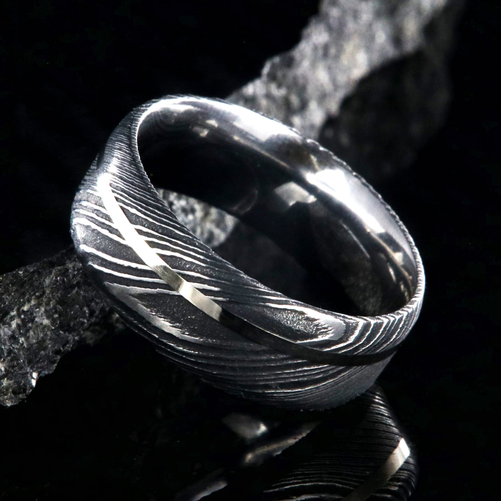 8mm wide black Damascus steel wedding band with a white gold inlay and flat profile