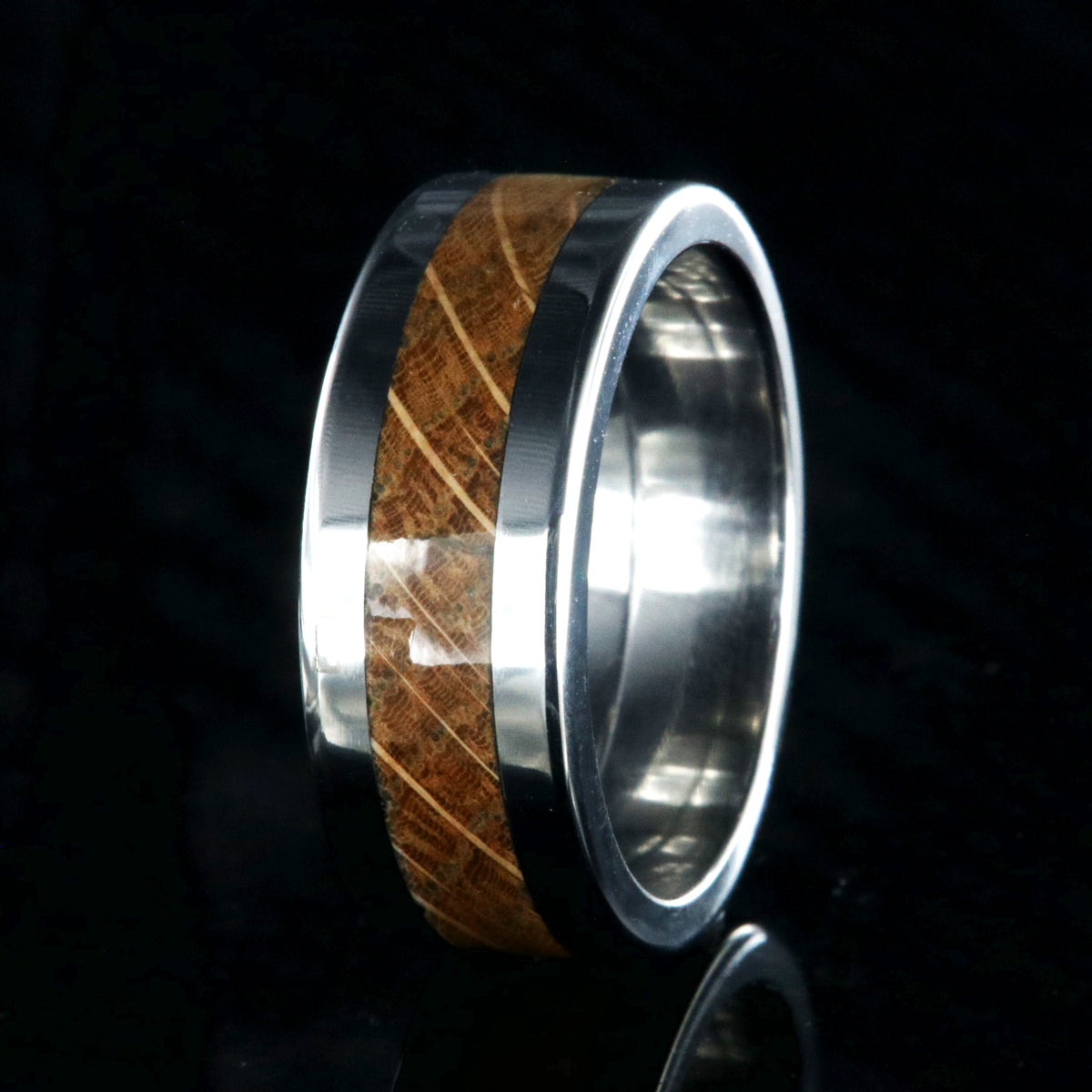 8mm wide wedding band with titanium edges and a whiskey barrel sleeve