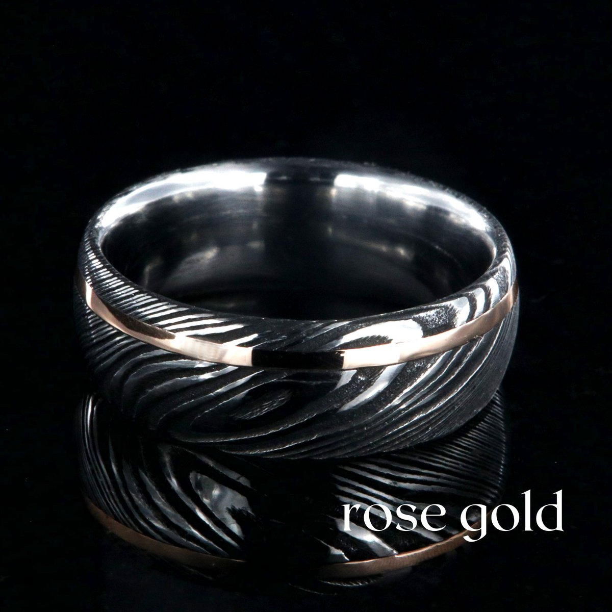 8mm wide Damascus steel ring with rose gold inlay