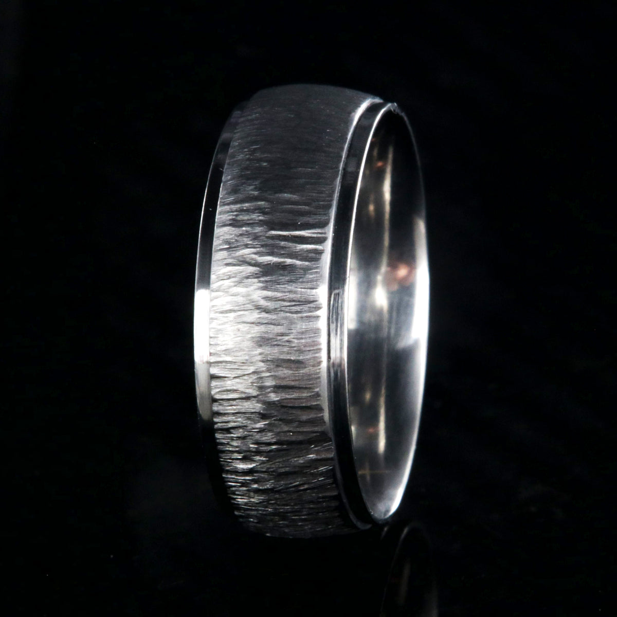 8mm wide titanium wedding band with a raised center and tree bark finish