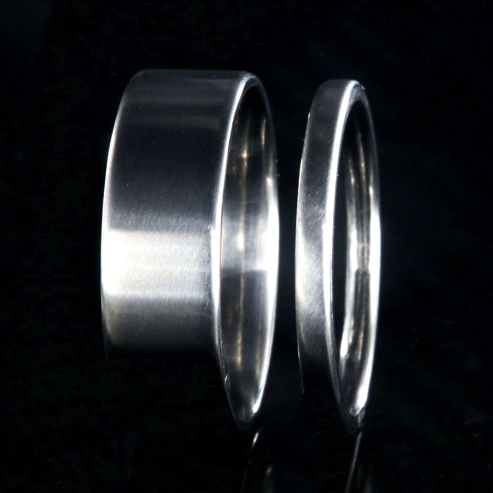 7mm and 2mm wide matching titanium wedding band set with a flat profile