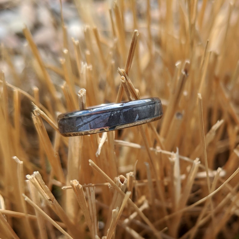 4mm wide women&#39;s meteorite wedding band with a rounded profile and titanium edges and sleeve