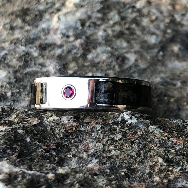 6mm wide titanium ring with a dinosaur inlay and bezel set ruby