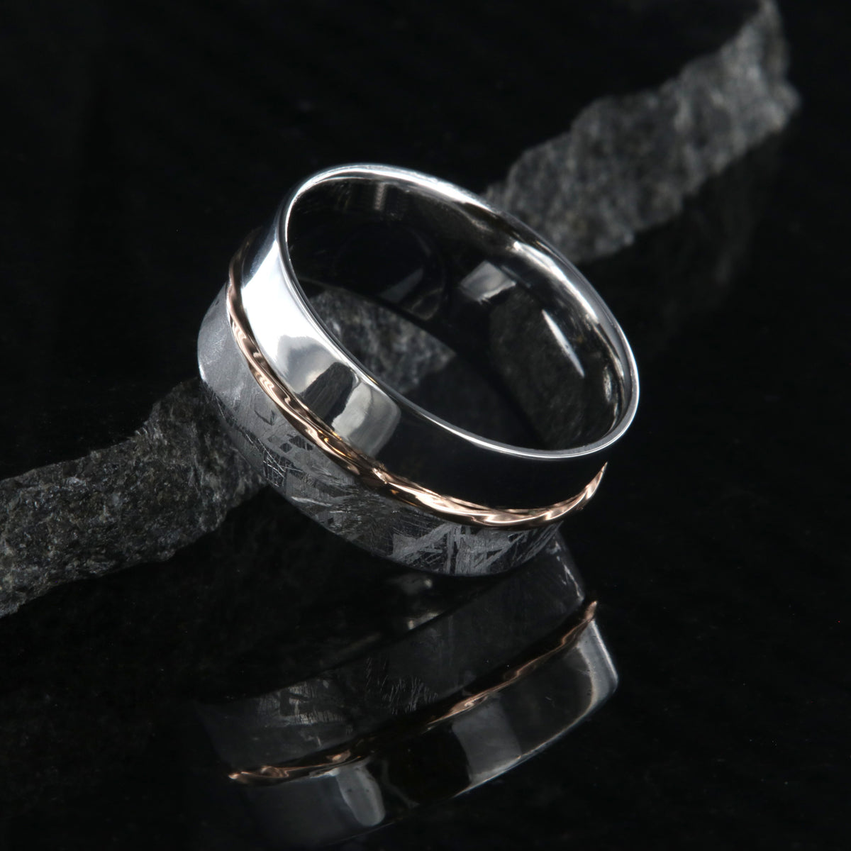 8mm wide men&#39;s wedding band with one half meteorite and the other of polish cobalt with a twisted rose gold inlay