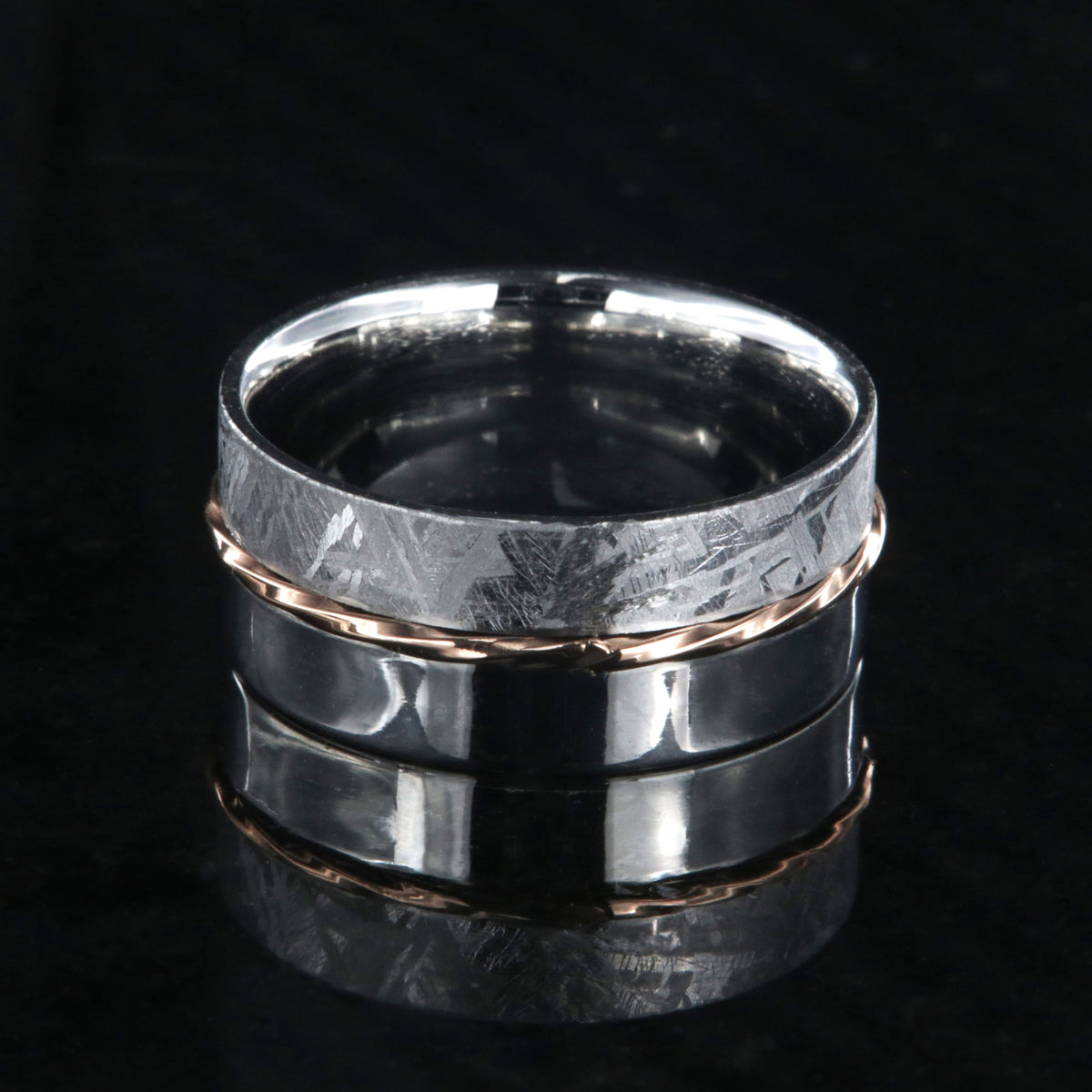 8mm wide men&#39;s wedding band with one half meteorite and the other of polish cobalt with a twisted rose gold inlay