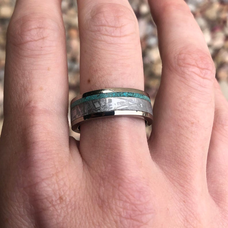 7mm wide cobalt ring with meteorite and a thin turquoise edge inlay on man&#39;s hand