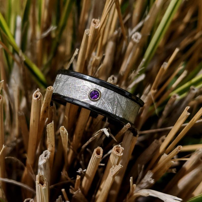 7mm wide meteorite ring with a 3mm purple amethyst stone and black zirconium edges and sleeve