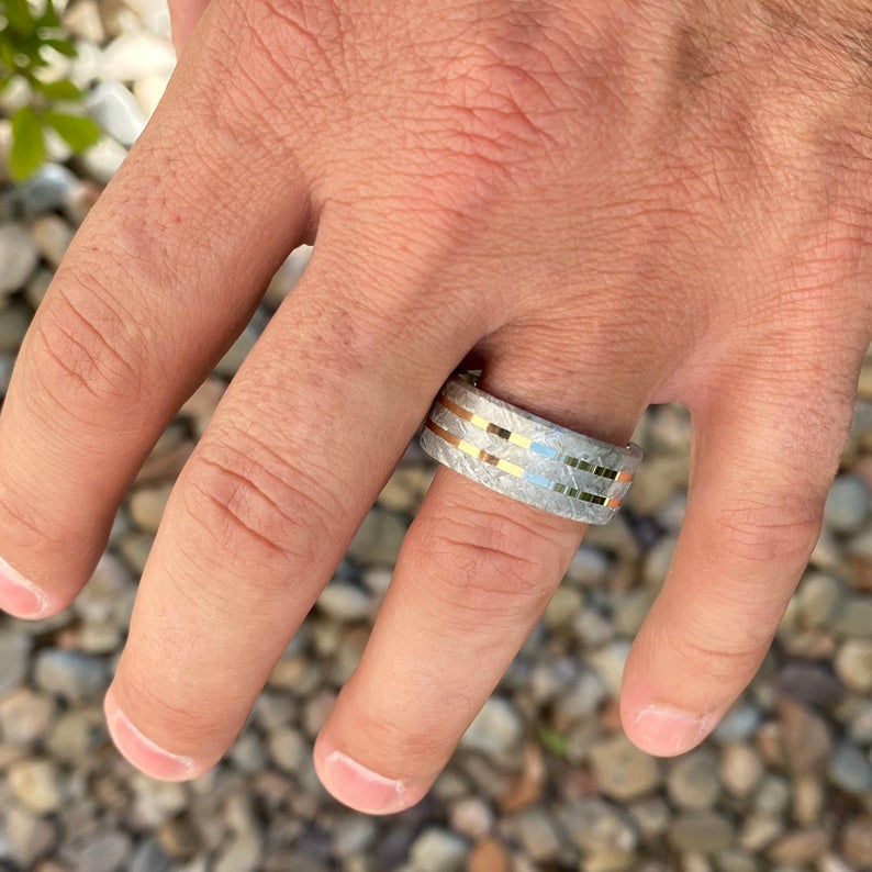 10mm wide cobalt wedding band with Gibeon meteorite and dual yellow gold inlays on man&#39;s hand