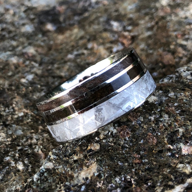 10mm wide men&#39;s wedding band with a wide Gibeon meteorite edge, a thin dinosaur bone fossil inlay, and thin redwood edge