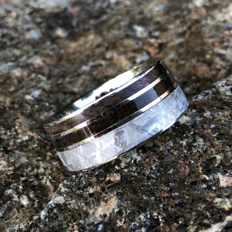 10mm wide men's wedding band with a wide Gibeon meteorite edge, a thin dinosaur bone fossil inlay, and thin redwood edge