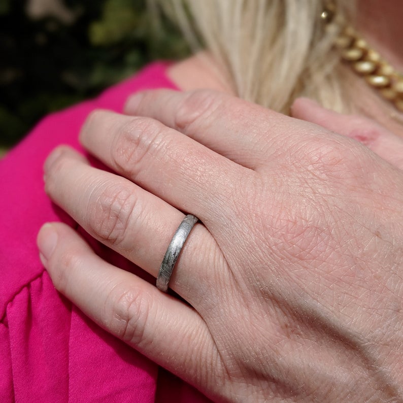 3mm wide women&#39;s meteorite ring with rounded profile on woman&#39;s hand