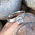 4mm wide women's meteorite engagement ring with a princess cut moissanite stone