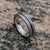 5mm wide Gibeon meteorite wedding band with a dark dinosaur bone inlay