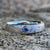 5mm wide women's meteorite ring with rounded profile and a blue sapphire set in a gold bezel