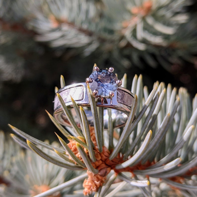 6mm wide women's meteorite engagement ring with a round aquamarine stone