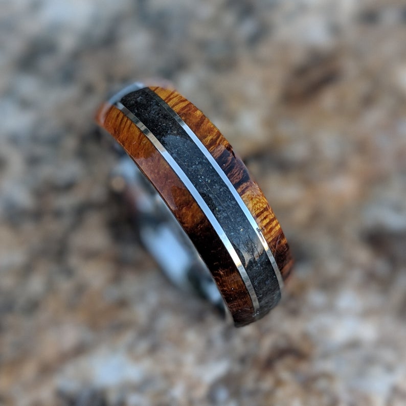 7mm wide cobalt wedding ring with Arizona ironwood edges and a centered black dinosaur bone inlay