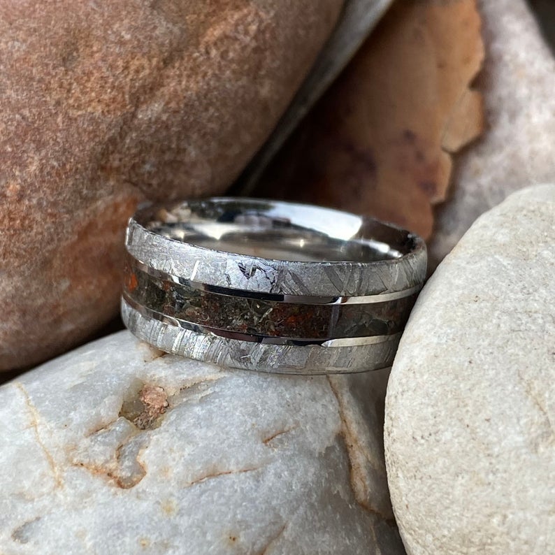 8mm wide meteorite ring with a cobalt sleeve, meteorite edges, and a combination of dinosaur bone and obsidian centered inlay